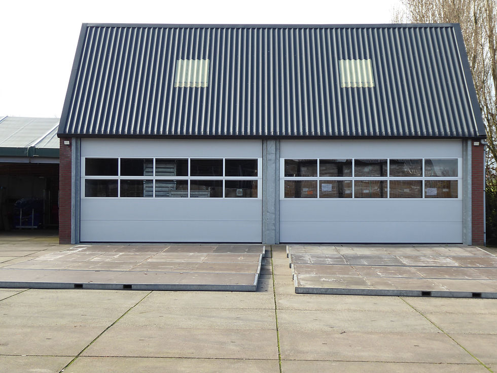 Commercial building with corrugated metal cladding and two overhead doors