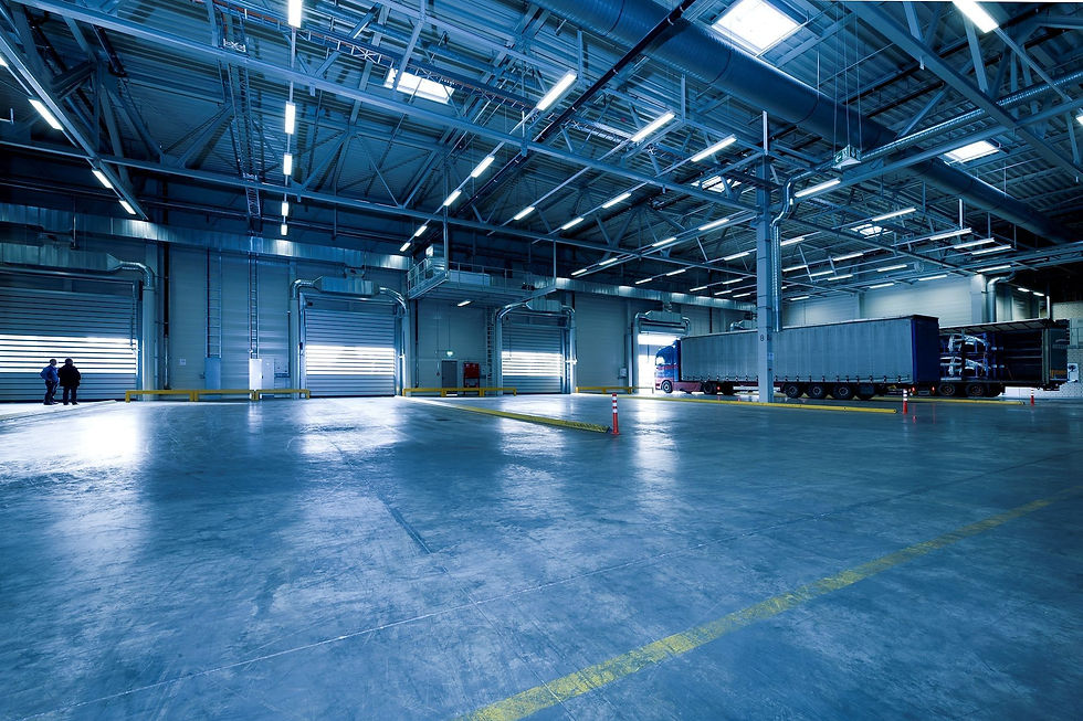 Industrial warehouse interior with blue wall panels and a high steel roof
