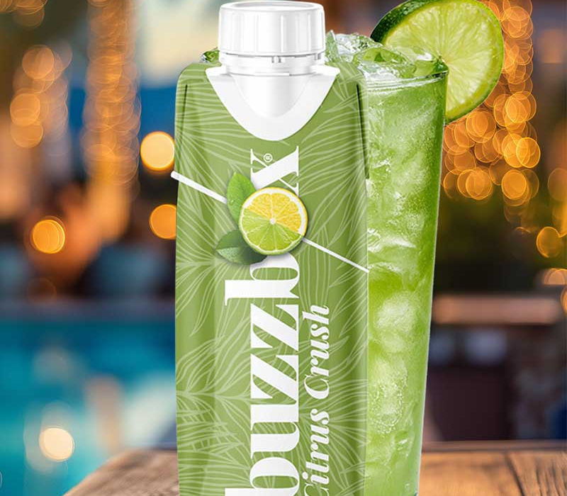 Green Crush bottle on a wooden table with palm trees in the background