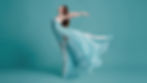 Dancer with a flowing aqua dress against an aqua backdrop