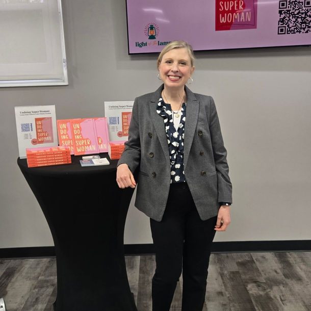 Susan Wiesemann at podium with her book