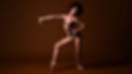 Ballerina with big hair against a maroon backdrop