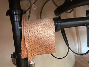 Towel covering pipe drip spot