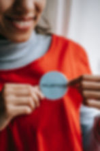 Proud volunteer showing their voluneer badge