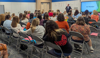 Ron Reed Speaking in front of audience.