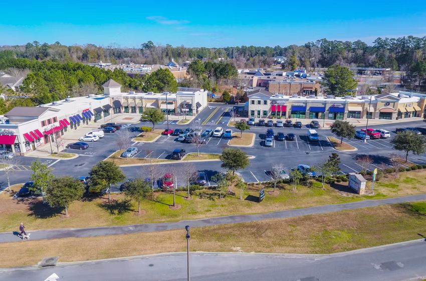 Old Towne Berwick Shopping Center aerial view with multiple retail buildings, parking lots, road frontage, and landscaping