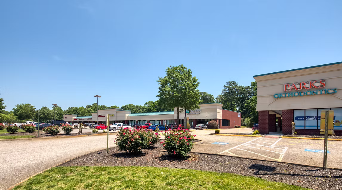 Villages Kiln Creek shopping center exterior with storefronts, parking lot, financial services, and retail tenants