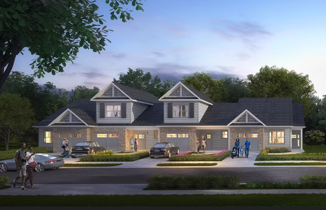Greenbrier Park Townhomes exterior rendering with attached garages, front porches, landscaped walkways, and evening lighting