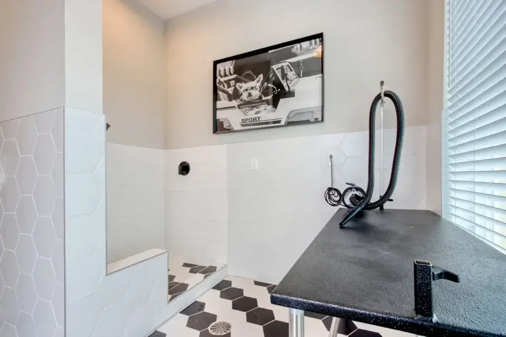 The Landing at Coventry dog spa with pet wash station, grooming table, tile walls, and pet-friendly amenities
