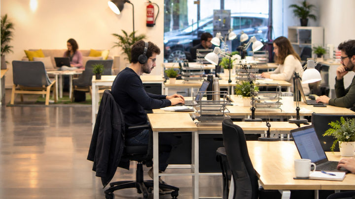 Personas trabajando en puestos fijos en un coworking en Vigo