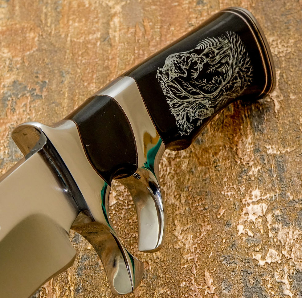 Thumbnail: The buffalo horn handle is engraved with a detailed woodland scene centered around a great tree with spreading roots