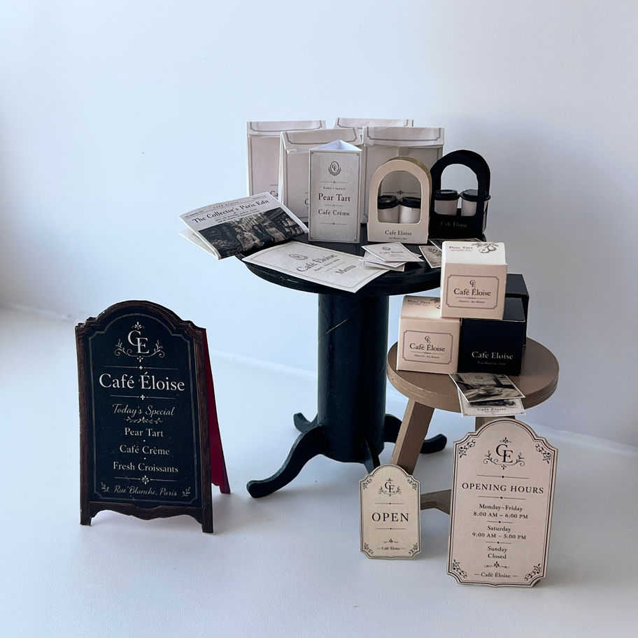 Printable 1:6 scale miniature café set with doll-sized boxes, menu, newspaper, signs and packaging for fashion doll dioramas