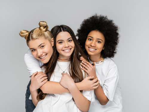 3 diverse girls hugging and smiling
