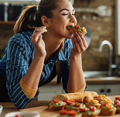 young-woman-enjoying-taste-healthy-bruschetta-with-her-eyes-closed-kitchen.jpg
