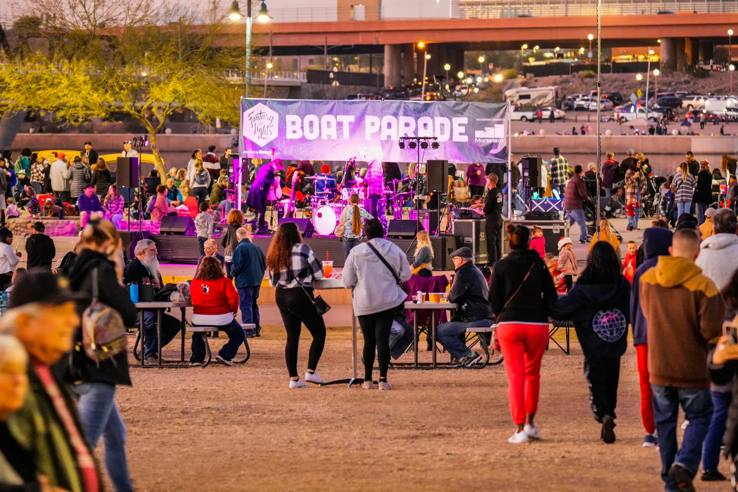 Parents and families enjoying holiday visuals from lakeside in Tempe
