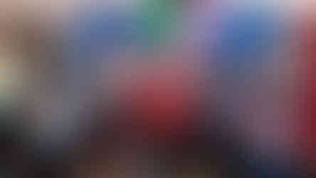 Adult day program members standing together at a movie theater in Lakeside Arizona, holding popcorn, drinks, and candy during a member chosen community outing.