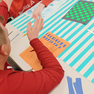 Members smiling and interacting during paper weaving activity at Lexington DTA