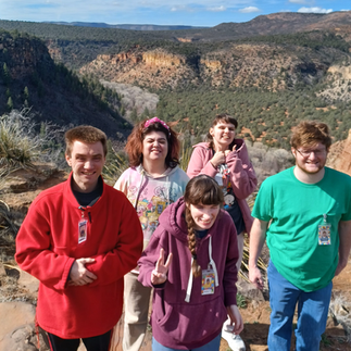 Lexington Services DTA members smiling in front of a mountain landscape during their Cedar Canyon outing.