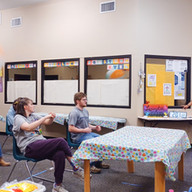 Members and staff enjoy a moment of laughter and friendly competition during a chair volleyball game.
