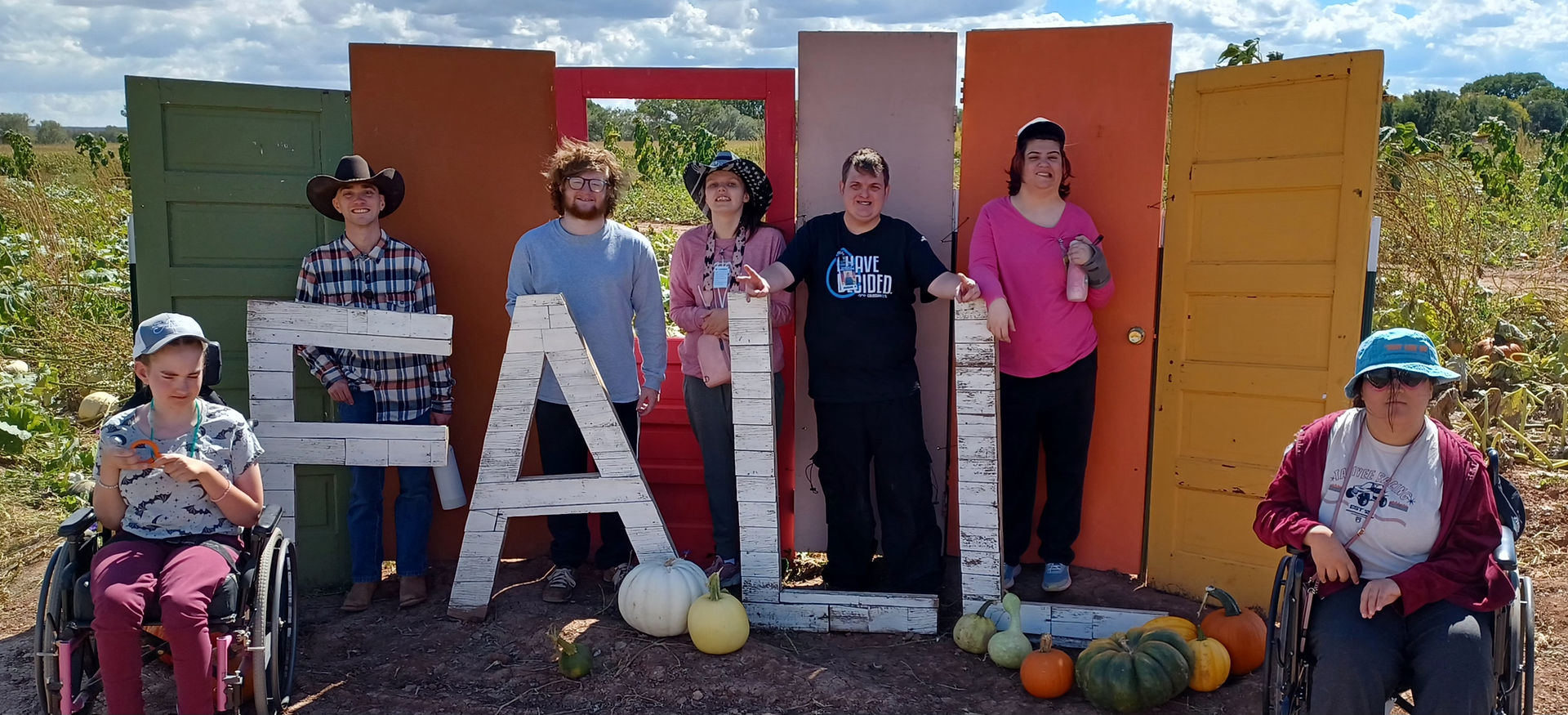 Lexington Services Show Low adult day program group posing at the FALL display