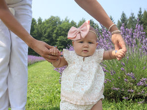 Daughter being lovingly supported by mother in a beautiful lavender field.