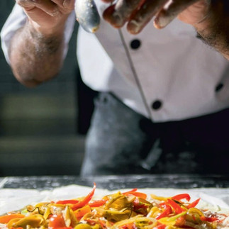 chef finishing up an italian dish