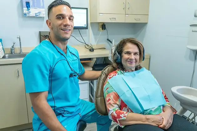 Dentist_Harrison_NJ_Doctor_and_Patient_smiling.webp