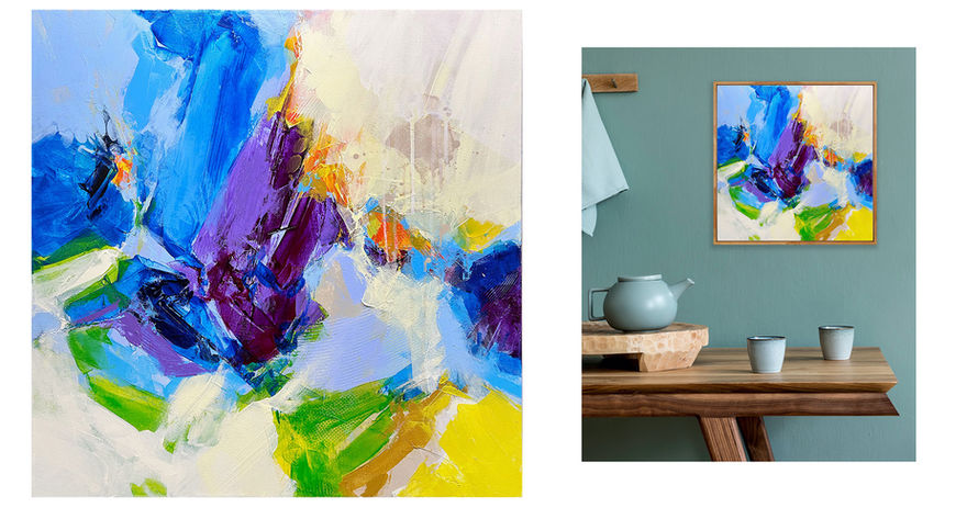 Abstract art of vibrant blues and purples next to a wooden table.