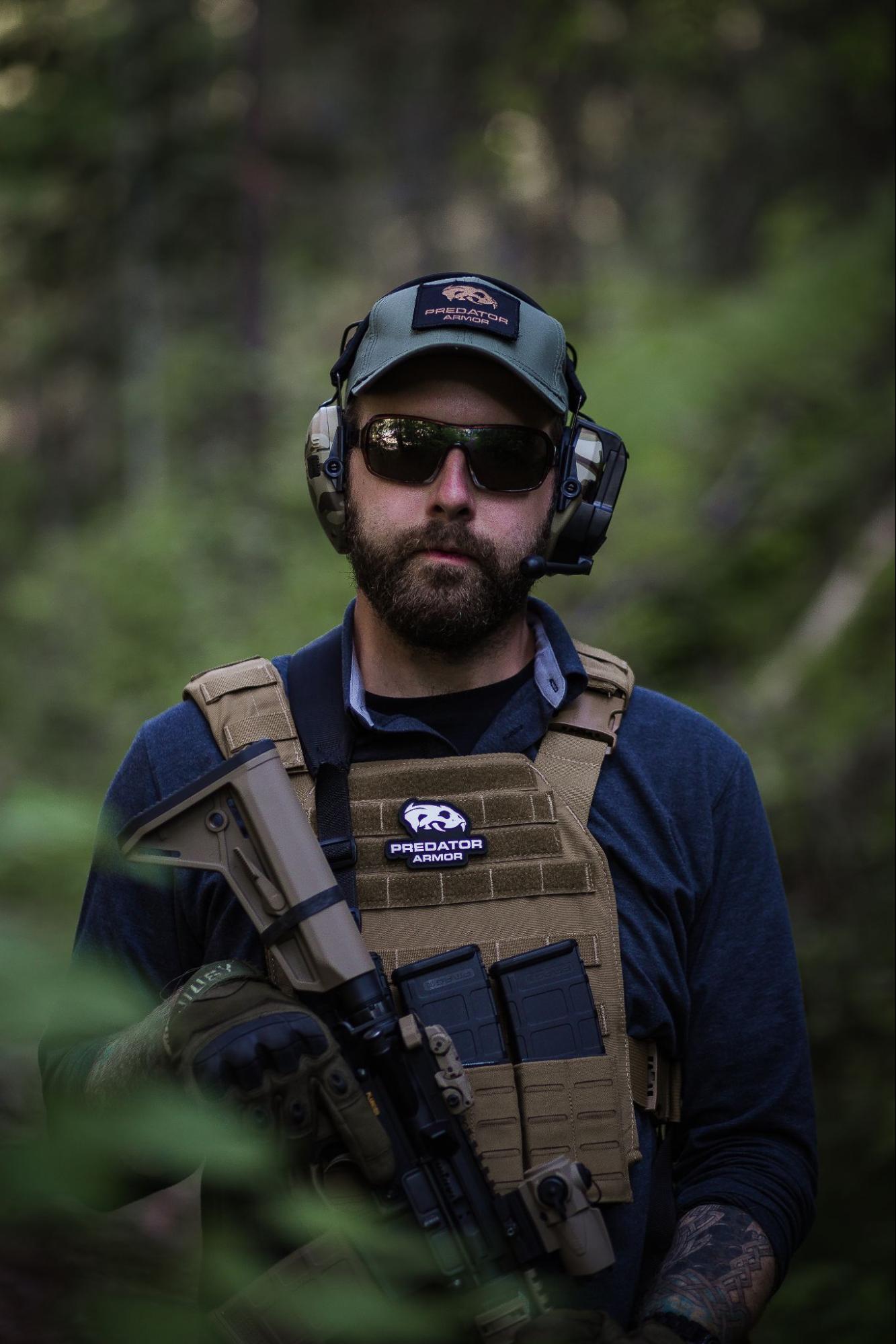 Plate carrier, rifle, ear pro, and glasses