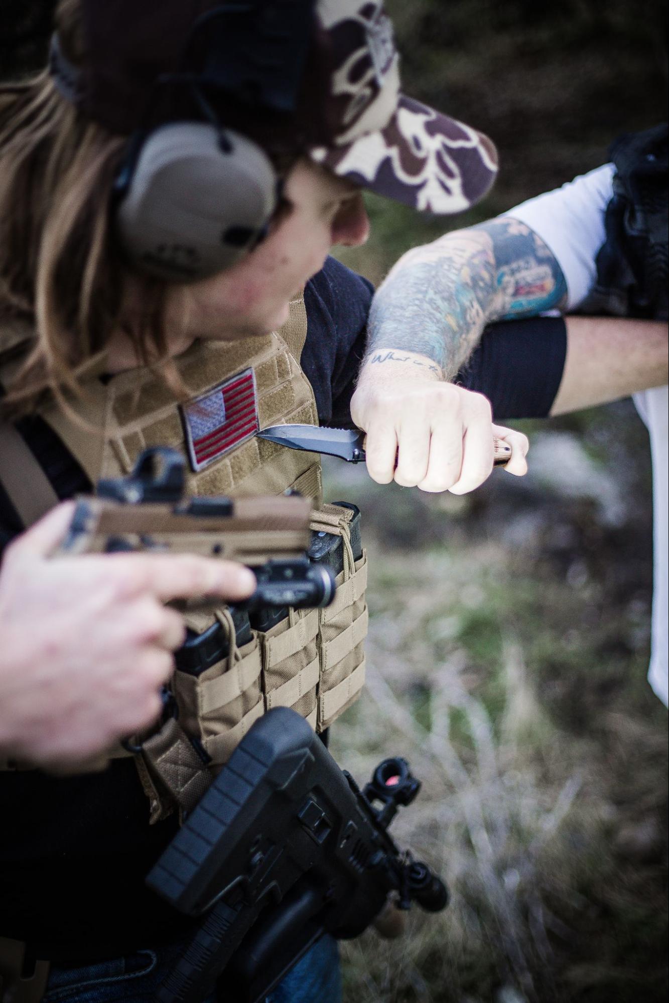 Man wearing body armor with a knife