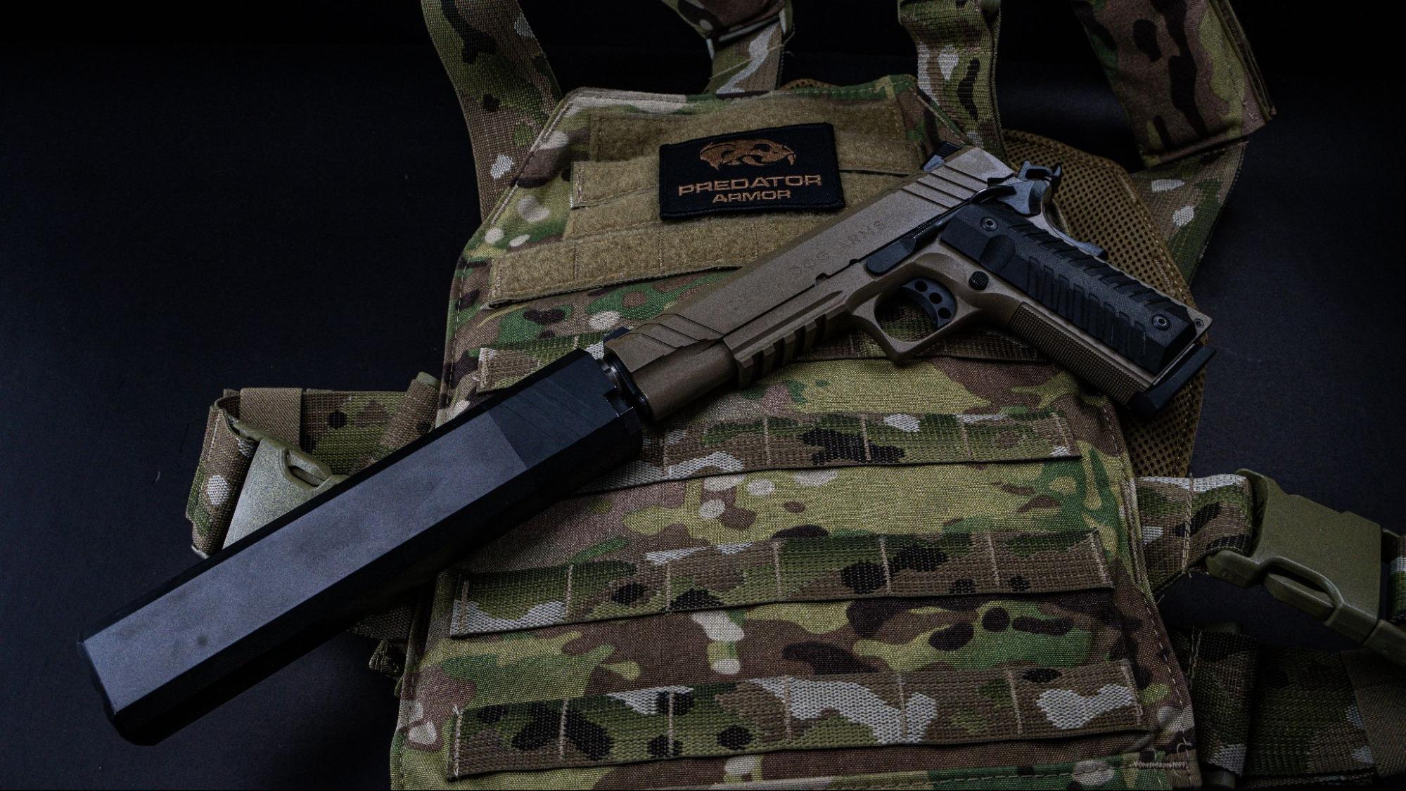 Pistol with a silencer and plate carrier