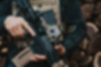 Man wearing plate carrier and body armor, holding a rifle with mags