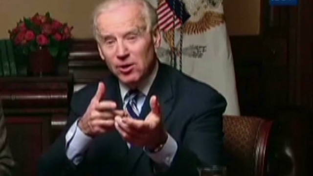 President Joe Biden shooting a shotgun