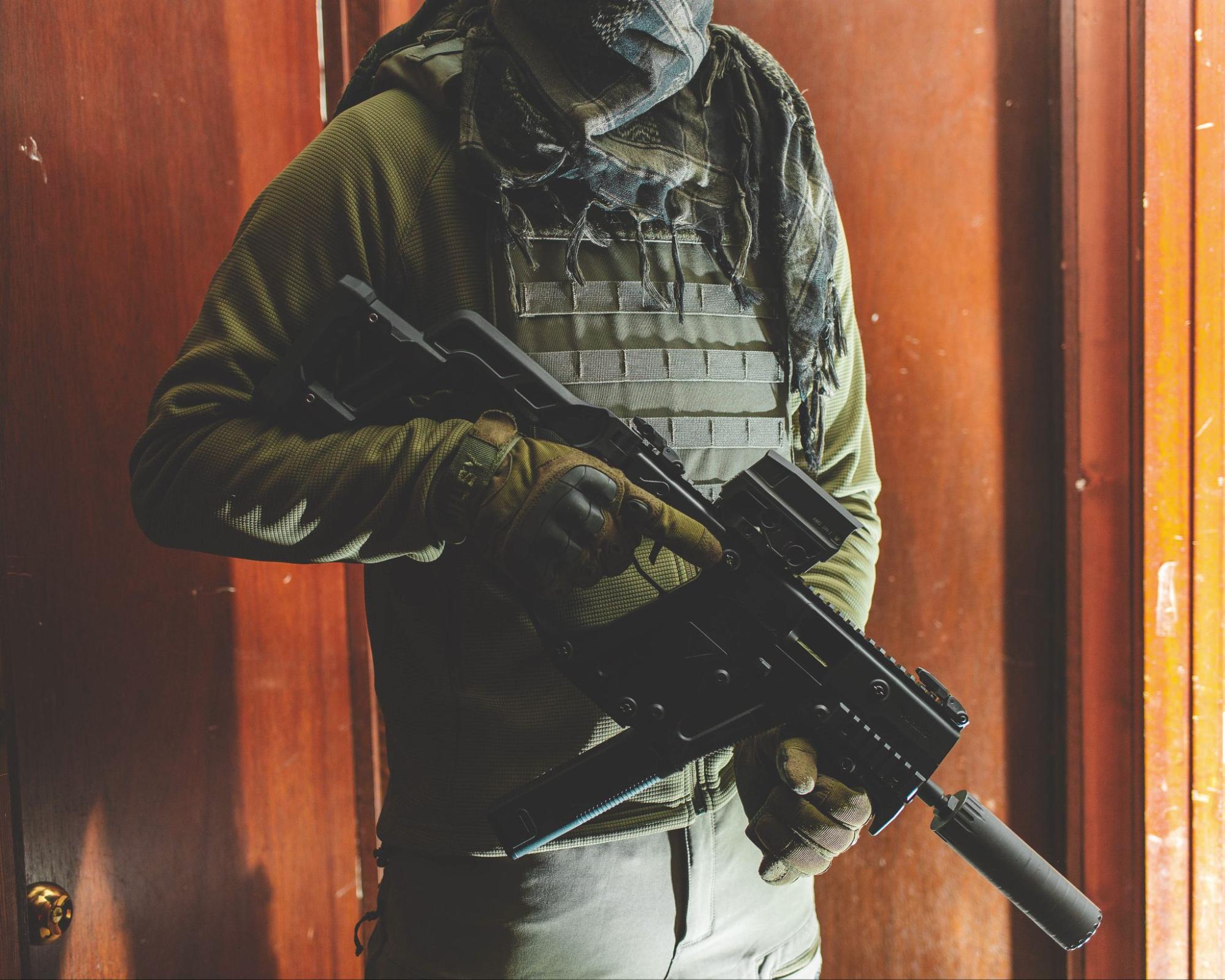 Man wearing tactical gear with pistol caliber carbine