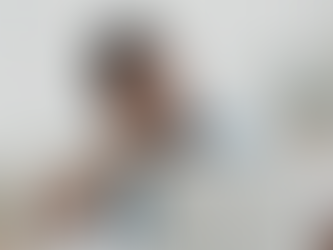 A tired man sitting at his desk, leaning on his hand while looking at his laptop, illustrating fatigue, burnout, or feeling mentally drained.