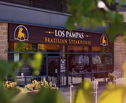 Exterior of Los Pampas Brazilian Steakhouse in Halifax with signage and outdoor seating