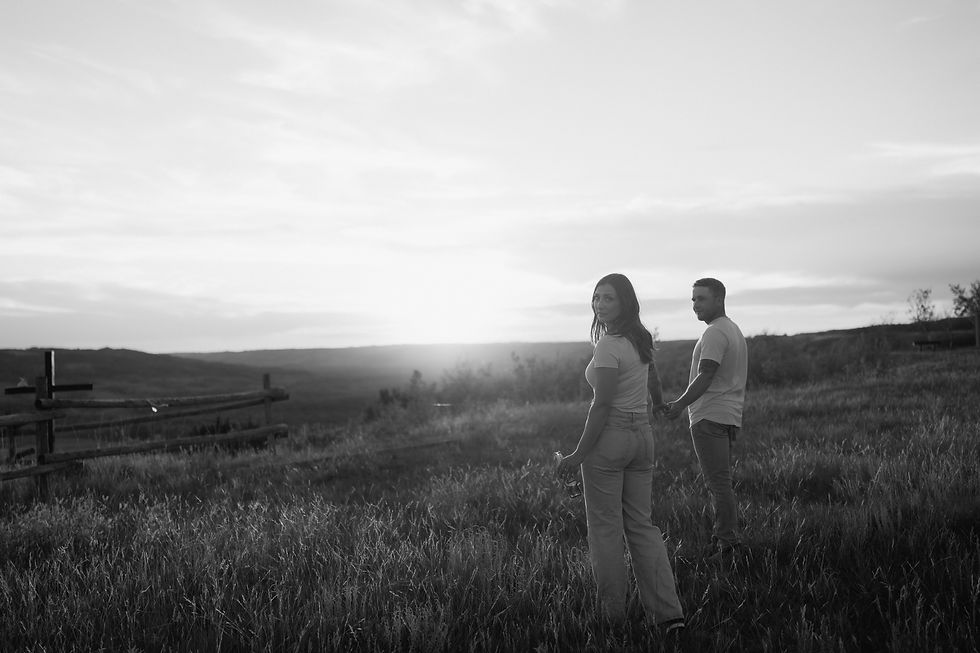 Get inspired by this golden-hour countryside engagement session with vintage flair, personalized props, and romantic aesthetics. Captured by Lloydminster photographer Sarah Thorpe.