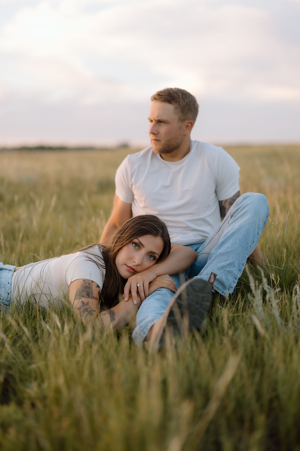 Get inspired by this golden-hour countryside engagement session with vintage flair, personalized props, and romantic aesthetics. Captured by Lloydminster photographer Sarah Thorpe.