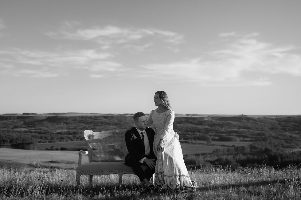 Get inspired by this golden-hour countryside engagement session with vintage flair, personalized props, and romantic aesthetics. Captured by Lloydminster photographer Sarah Thorpe.
