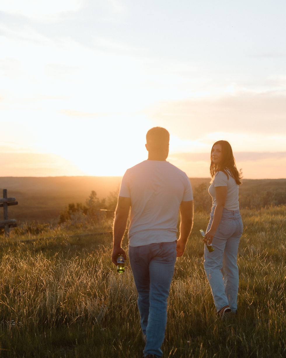 Get inspired by this golden-hour countryside engagement session with vintage flair, personalized props, and romantic aesthetics. Captured by Lloydminster photographer Sarah Thorpe.