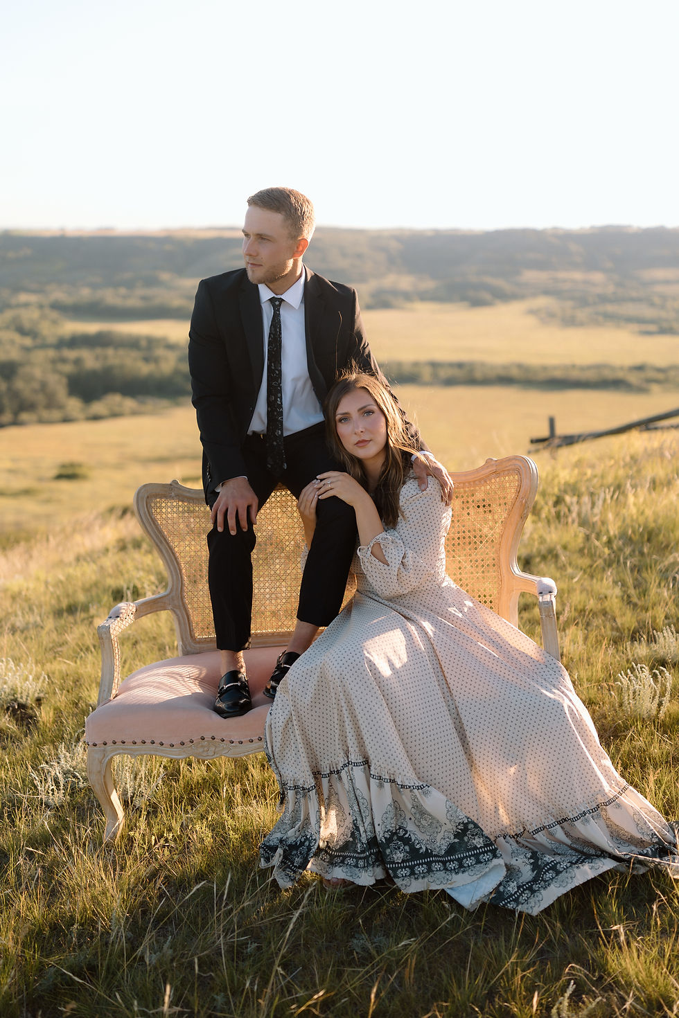 Get inspired by this golden-hour countryside engagement session with vintage flair, personalized props, and romantic aesthetics. Captured by Lloydminster photographer Sarah Thorpe.