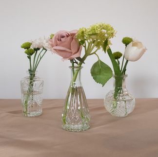 Clear vintage-style bud vases with florals