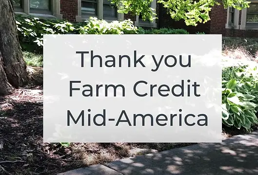 white box with the words Thank you Farm Credit Mid-America in front of trees in background