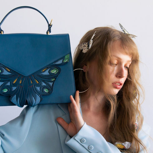 Luxury full-grain leather handbags inspired by Asian heritage, featuring hand-carved and hand-painted embossed designs.