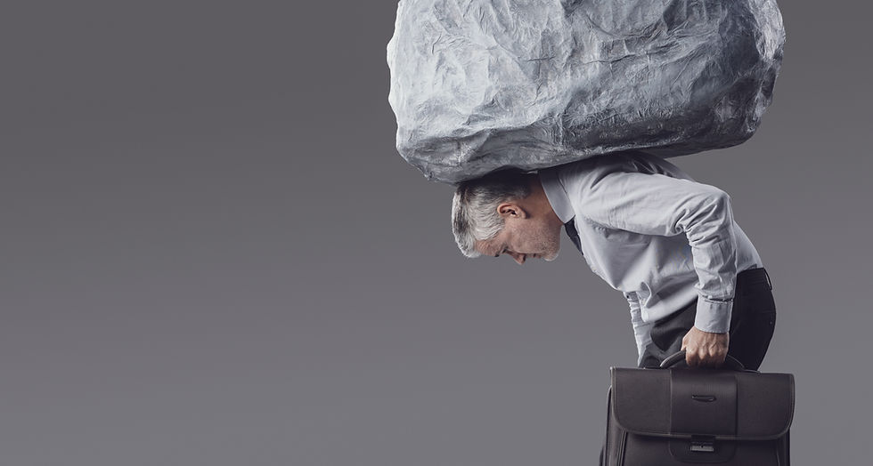 A businessman carries a heavy boulder on his shoulders while walking with a briefcase sym