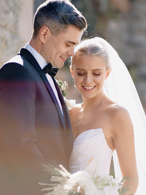 Bride and groom walking through Castle Leslie gardens