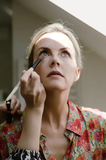close-up of bride while putting on her make-up before the ceremony