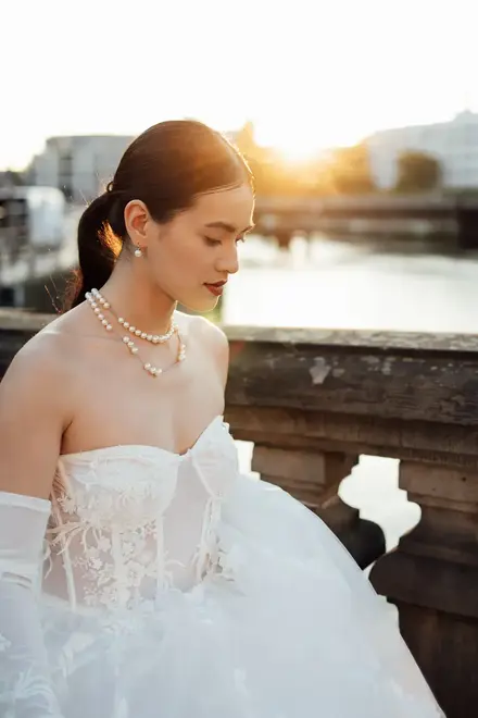 bride having a moment while portrait is taken during sunset in Berlin