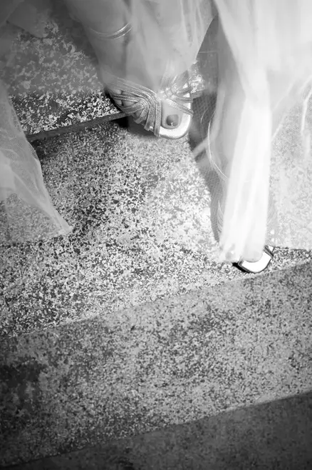 bride stepping down old stairs on her wedding day