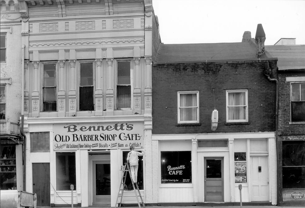 In 1963, Otis Howell of the Hannibal Courier-Post captured an image of remodeling in progress at 322-324 N. Main St., home to Bennett’s Cafe/Bennett’s Old Barber Shop Cafe. In 2026, both of the pictured buildings house a portion of Pat Waelder’s expansive fabric shop, Hickory Stick. Both of the buildings are now owned by Frank and Sara Anton North. Otis Howell photo, Steve Chou collection.